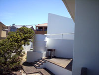 View of the braai with the court yard wall and the garage in the background from the balcony